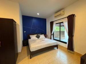 a bedroom with a bed with a blue wall at New! MATA Garden resort Ao Nang in Ao Nang Beach +56 photos