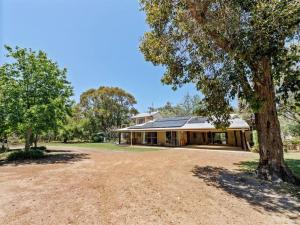 a house with a tree in front of it at Orchard Homestead Countryside Retreat in Yallingup Siding