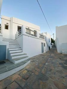 a white building with stairs on the side of it at Artemonas White Escape in Sifnos