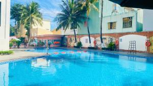 a large blue swimming pool in front of a building at Muong Thanh Quy Nhon Hotel in Quy Nhon