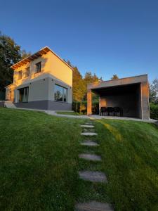 a house on a hill with a path leading to it at The Houses - Chata u sjezdovky 2 in Velké Meziříčí