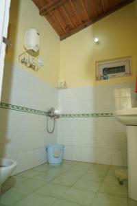 a bathroom with a toilet and a sink at Dream Stay in Bhīm Tāl