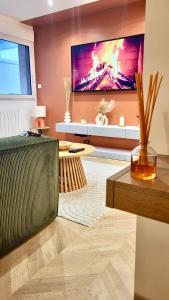 a living room with a large flat screen tv at - KALON - CONCARNEAU - SALLE CINÉMA - PLAGE À 100m - VILLE CLOSE À PIEDS - WIFI - Center & beach within walking distance - in Concarneau +32 photos