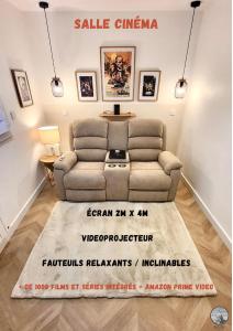 a living room with a couch and a table at - KALON - CONCARNEAU - SALLE CINÉMA - PLAGE À 100m - VILLE CLOSE À PIEDS - WIFI - Center & beach within walking distance - in Concarneau