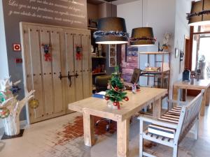 a room with a table with a christmas tree on it at Hotel Rural Porta Coeli - Dehesa Santa Lucía in San Martín del Castañar