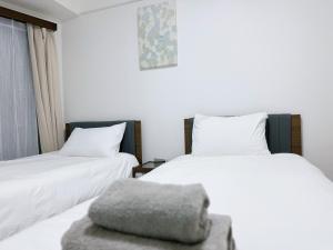 Postel nebo postele na pokoji v ubytování Tokyo Shinjuku Waseda House新宿早稲田