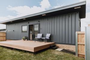a house with two chairs on a deck at Tiny Home in Scottsdale in Scottsdale