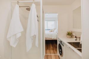 a small white kitchen with a washer and dryer at Tiny Home in Scottsdale in Scottsdale