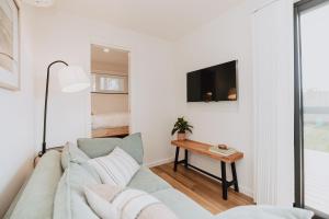 a living room with a couch and a tv at Tiny Home in Scottsdale in Scottsdale