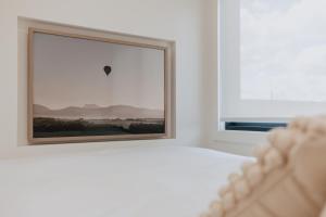 a bedroom with a bed and a window with a hot air balloon at Tiny Home in Scottsdale in Scottsdale
