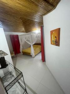 a room with a bed with a canopy in it at Teranga saly senegal in Saly Portudal