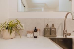 a kitchen counter with bottles of wine and a sink at Tiny Home in Scottsdale in Scottsdale