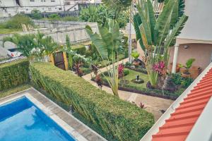 a view of a garden with a swimming pool at Guest Wharf - Côte Sauvage in Pointe-Noire