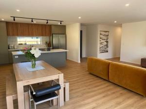a living room with a couch and a table at Brand new on Arthur in Invercargill