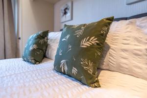 two pillows sitting on top of a bed at Countryside log cabin with HOT TUB! in Swarkeston