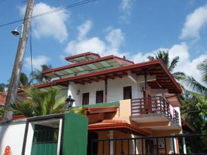 a house with a green and white at Leisure Home Mirissa in Mirissa +44 photos
