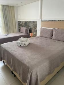 Кровать или кровати в номере Suites Amma Noronha