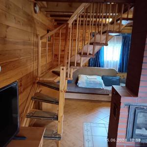 a room with a bunk bed and a staircase at Camping Bałtyk in Dźwirzyno