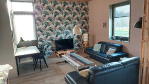 a living room with a couch and a fireplace at Bollenboet in Sint Maarten