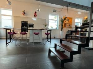 a kitchen with a table and stools in a room at Chez Marie in Rosheim