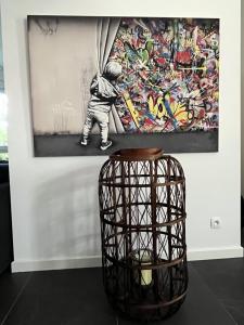 a painting of a baseball player on a wall with a basket at Chez Marie in Rosheim