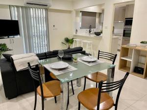 a dining table and chairs in a living room at CBD Esplanade Location - Quiet & Comfortable in Darwin +12 photos