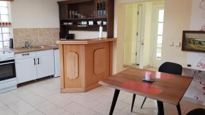a kitchen with a wooden table and a dining room at Villa Maria in Sassnitz
