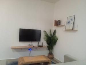 a living room with a flat screen tv on a wall at The Shore Seaview in Kota Kinabalu