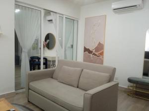 a living room with a couch and a mirror at The Shore Seaview in Kota Kinabalu