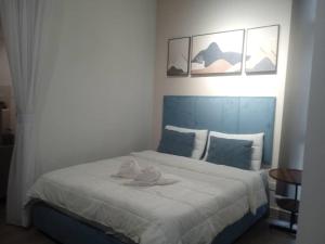 a bedroom with a bed with two towels on it at The Shore Seaview in Kota Kinabalu