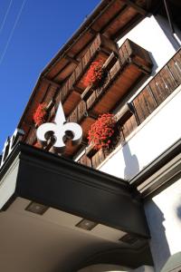 a building with a sign that says on it at Hotel Trieste in Cortina dʼAmpezzo