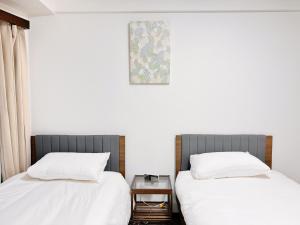 Postel nebo postele na pokoji v ubytování Tokyo Shinjuku Waseda House新宿早稲田
