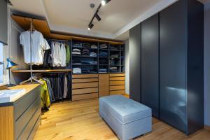 a walk in closet with a blue ottoman at Villa Bella in Sarajevo