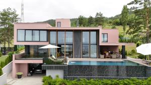 a pink house with a swimming pool at Villa Bella in Sarajevo