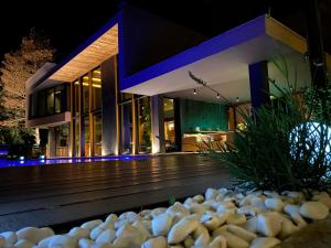 a house with a bunch of rocks in front of it at Villa Bella in Sarajevo
