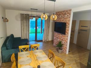 a living room with a table and a couch at Kopanicówki in Jaworzynka
