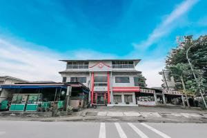 a building on the corner of a street at Scala Inn By Helocus in Medan