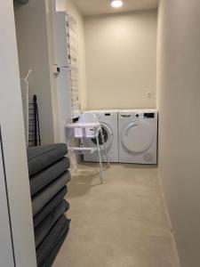 a laundry room with a washing machine and a washer at Beach House Terra in Zeebrugge