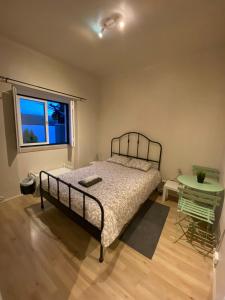 a bedroom with a bed and a table and a window at CHALLET AZENHAS in Bolembre de Baixo
