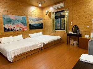 Letto o letti in una camera di He Ya Leisure Land B&B