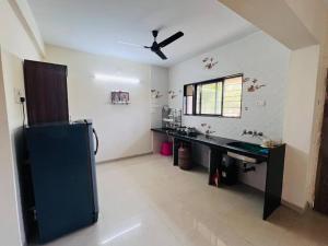 a bathroom with a sink and a ceiling fan at Susneh Homestay Reena Cottage in Srīvardhan +21 photos