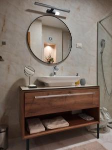 a bathroom with a sink and a mirror at NJANJA apartmani Zlatibor in Zlatibor +82 photos