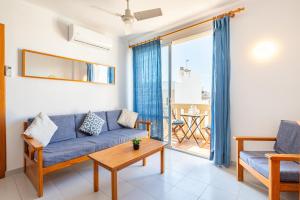 a living room with a couch and a table at C'an Vidal apto Menorca in Colonia Sant Jordi