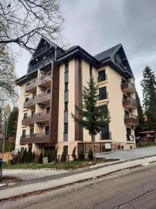 a large apartment building on the side of a street at NJANJA apartmani Zlatibor in Zlatibor
