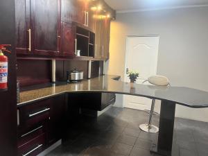 a kitchen with a counter and a table in it at Luband Stelties in Nelspruit
