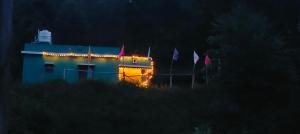 a building with christmas lights on it at night at Aamis Home Stay in Vattavada +1 photo