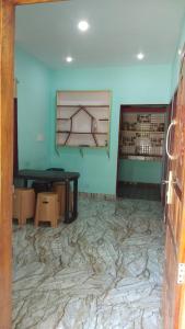 a room with a marble floor with a table and a window at Aamis Home Stay in Vattavada