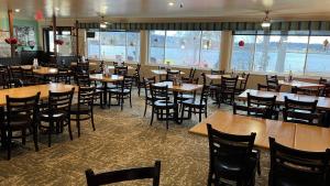 a dining room filled with tables and chairs at The Ash Grove Inn in Barrys Bay