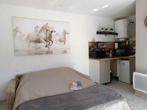 a bedroom with a picture of horses on the wall at Gîte la grange in Méneslies