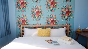 茅野市にあるGuesthouse HOALOHA 4 SEASONSのベッドルーム1室(花の壁掛けのベッド1台付)